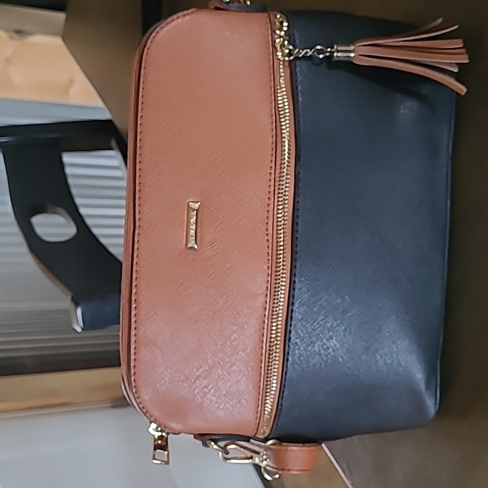 A black and brown Elim and Paul purse